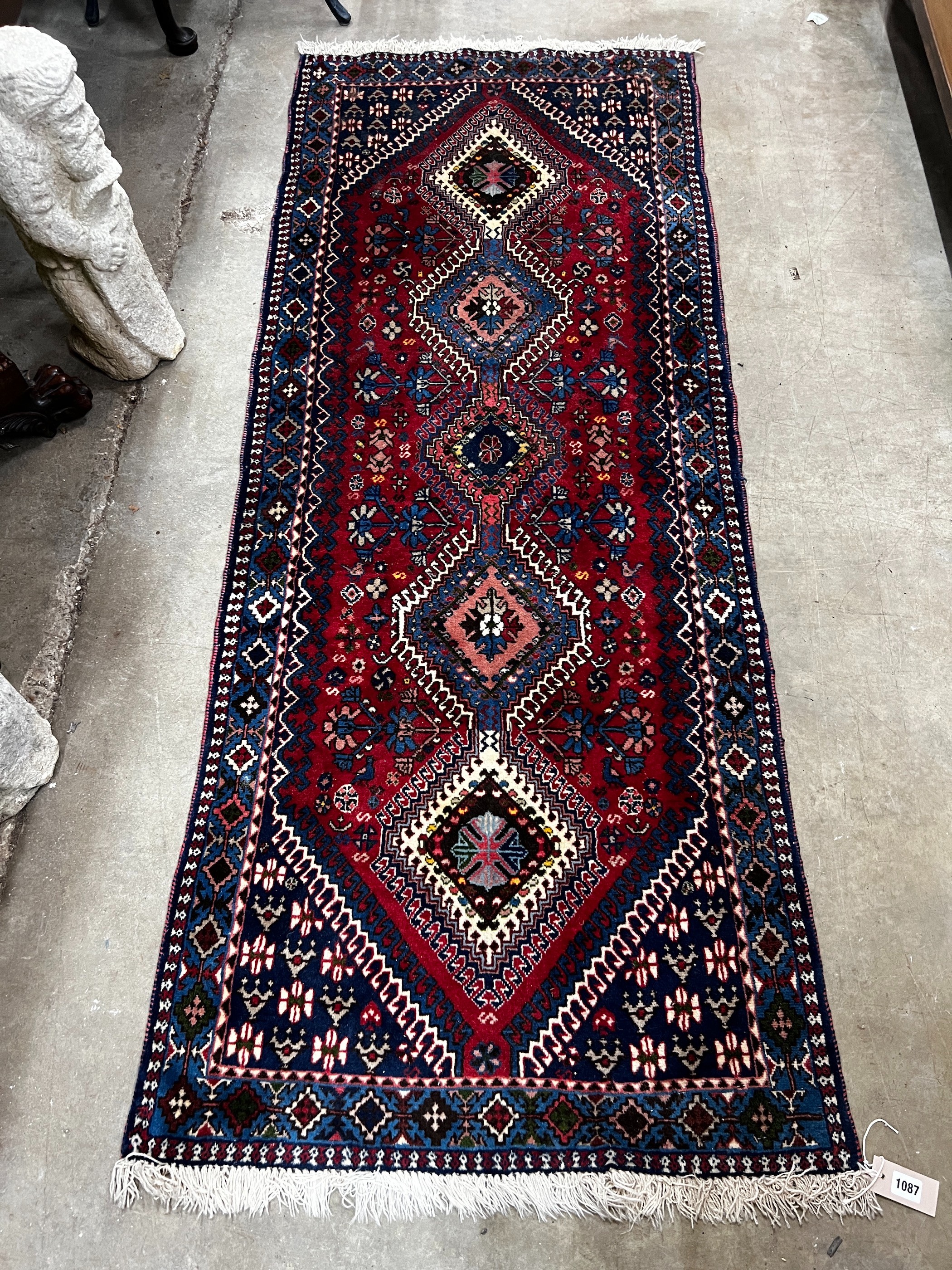 A Caucasian style red ground runner 200cm x 76cm